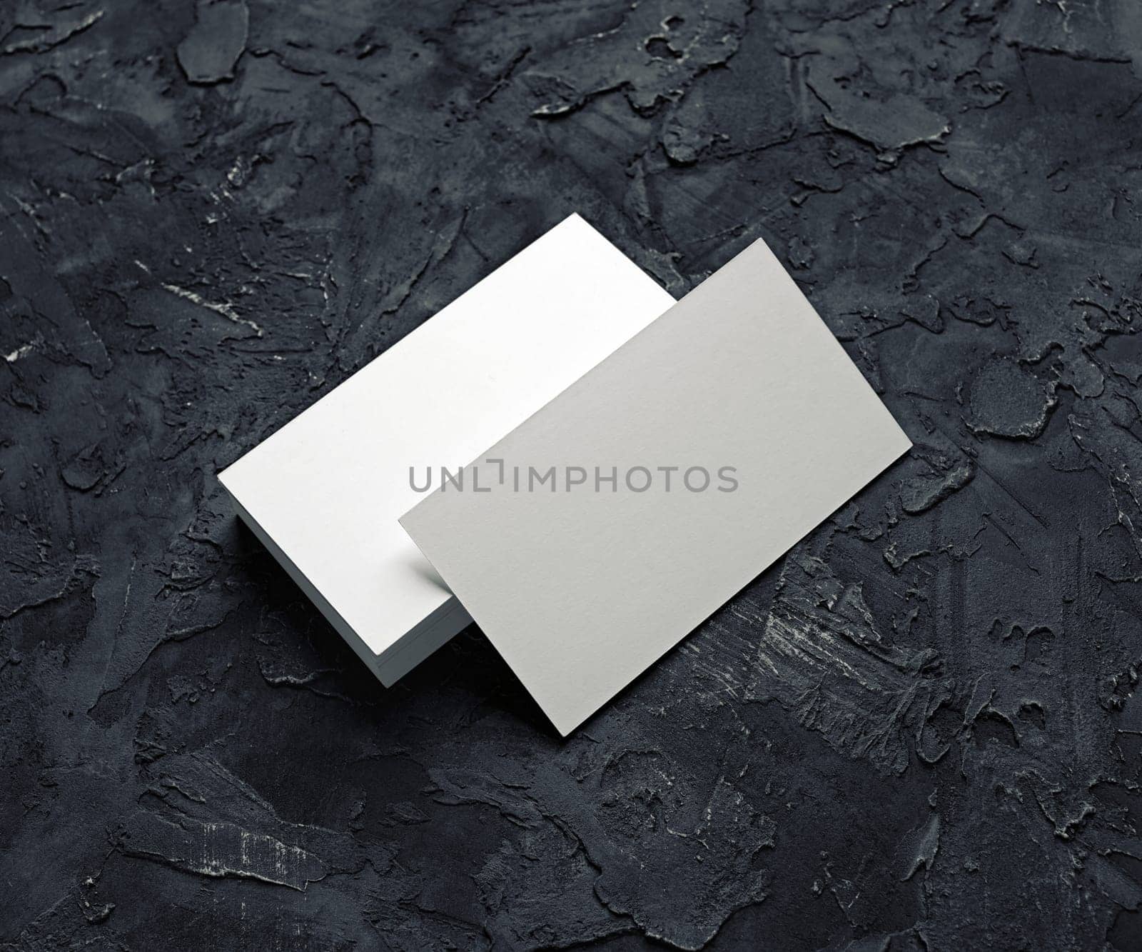Blank business cards template on black plaster background. Mockup for branding identity for designers.
