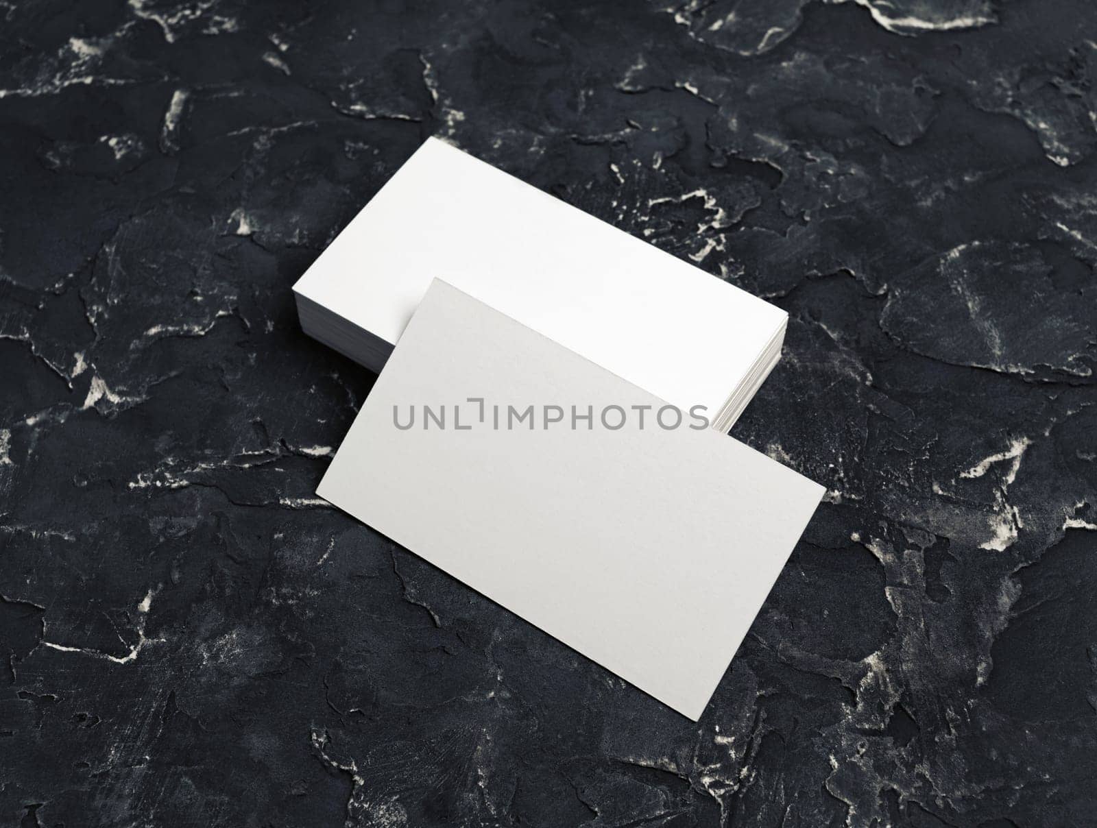 Blank white business cards on black plaster background. Mockup for branding identity.