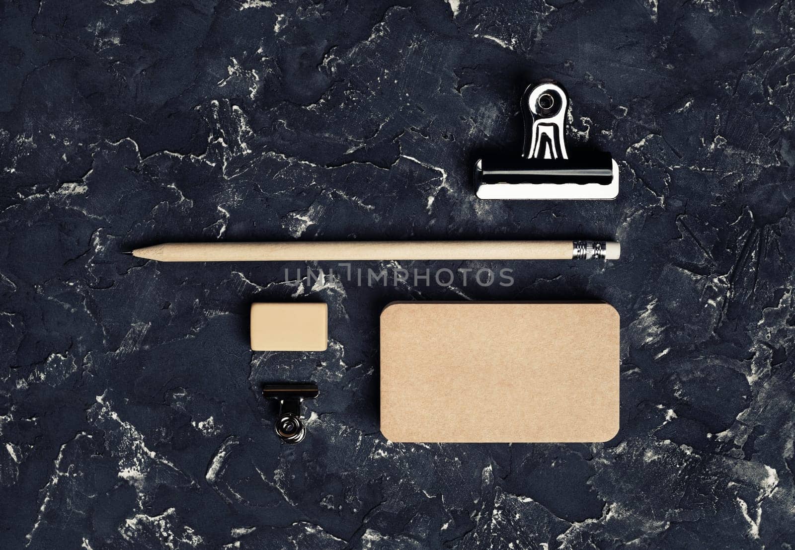 Vintage stationery mockup. Blank kraft business card, pencil, eraser and metal clips. Brand ID set. Top view.