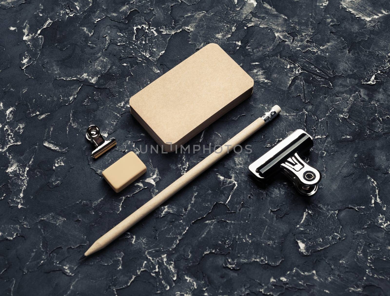 Blank vintage business cards, pencil, eraser and metal clips. Blank kraft stationery.