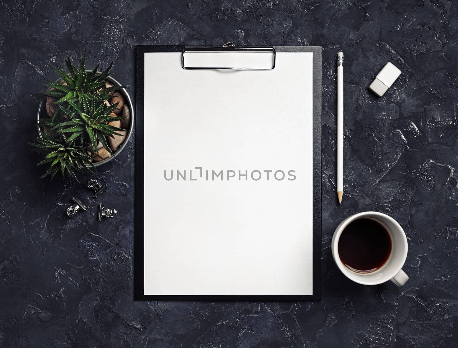 Blank stationery set on black plaster background. Top view.