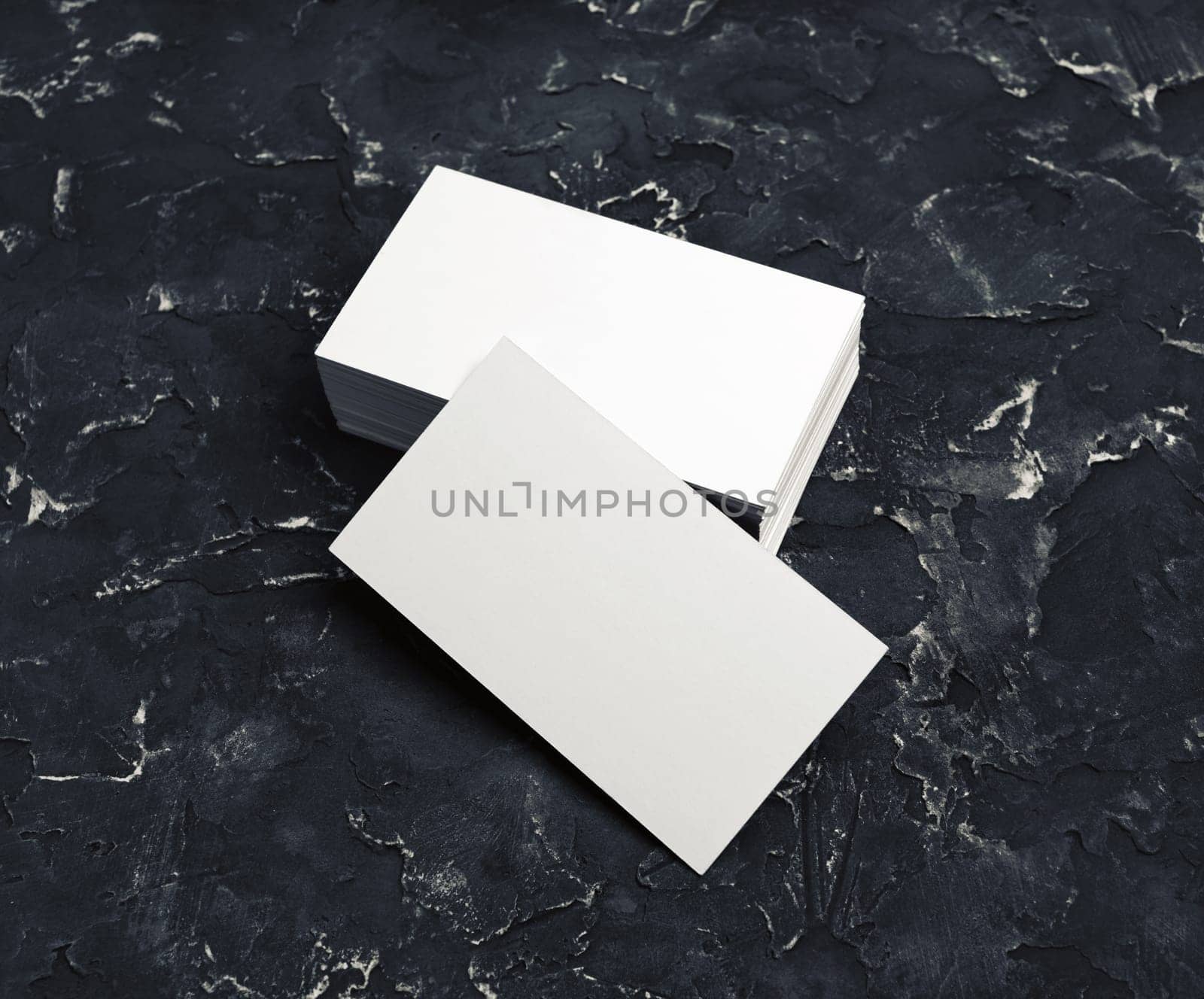 Blank business cards on black plaster background. Mockup for branding identity for designers.