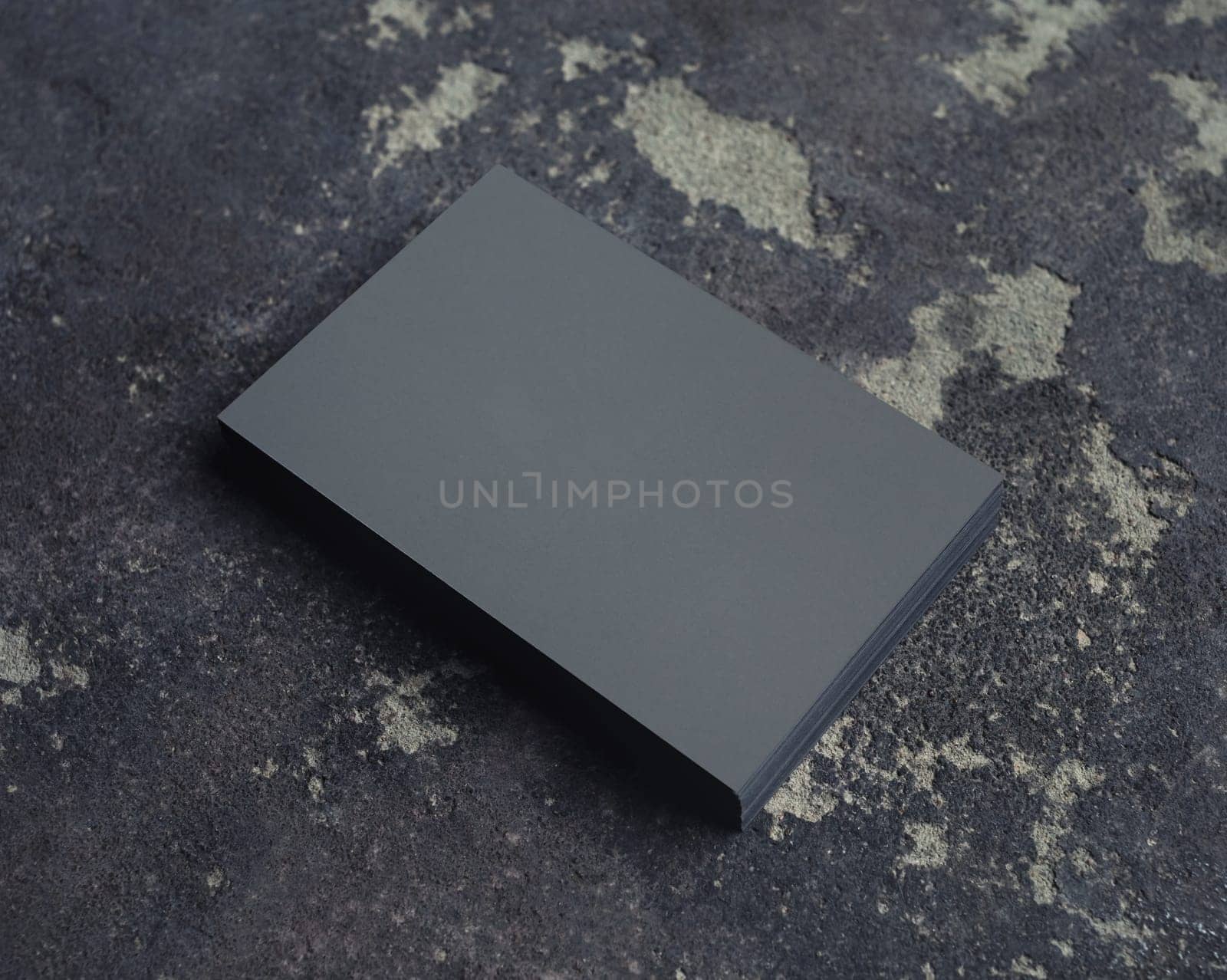 Stack of grey business cards on concrete background. Branding mock up.