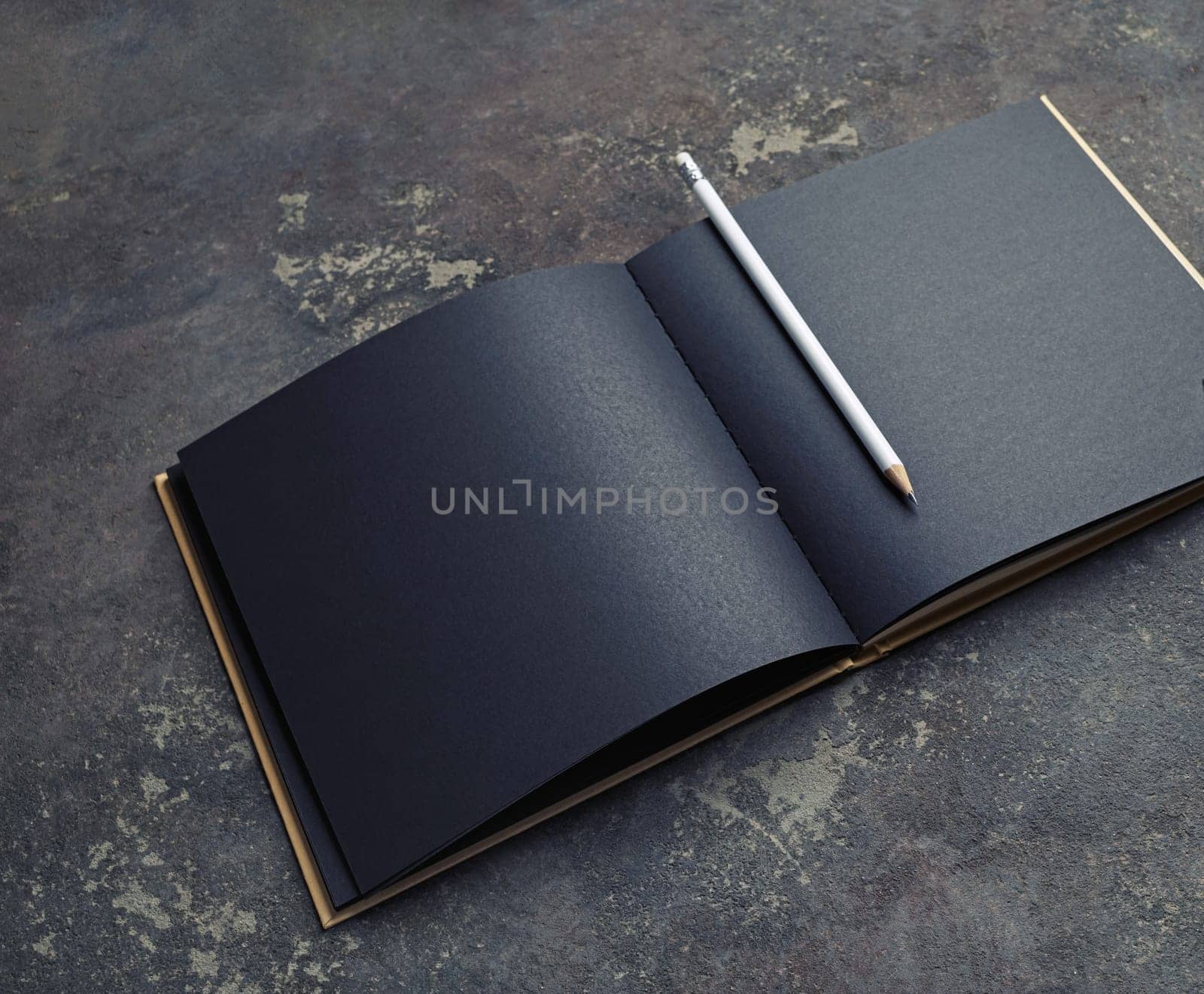 Blank black book and pencil mock up on concrete background.
