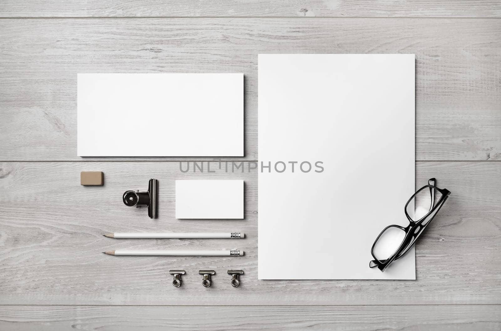 Blank branding stationery set. Business brand template on light wooden background. Top view.