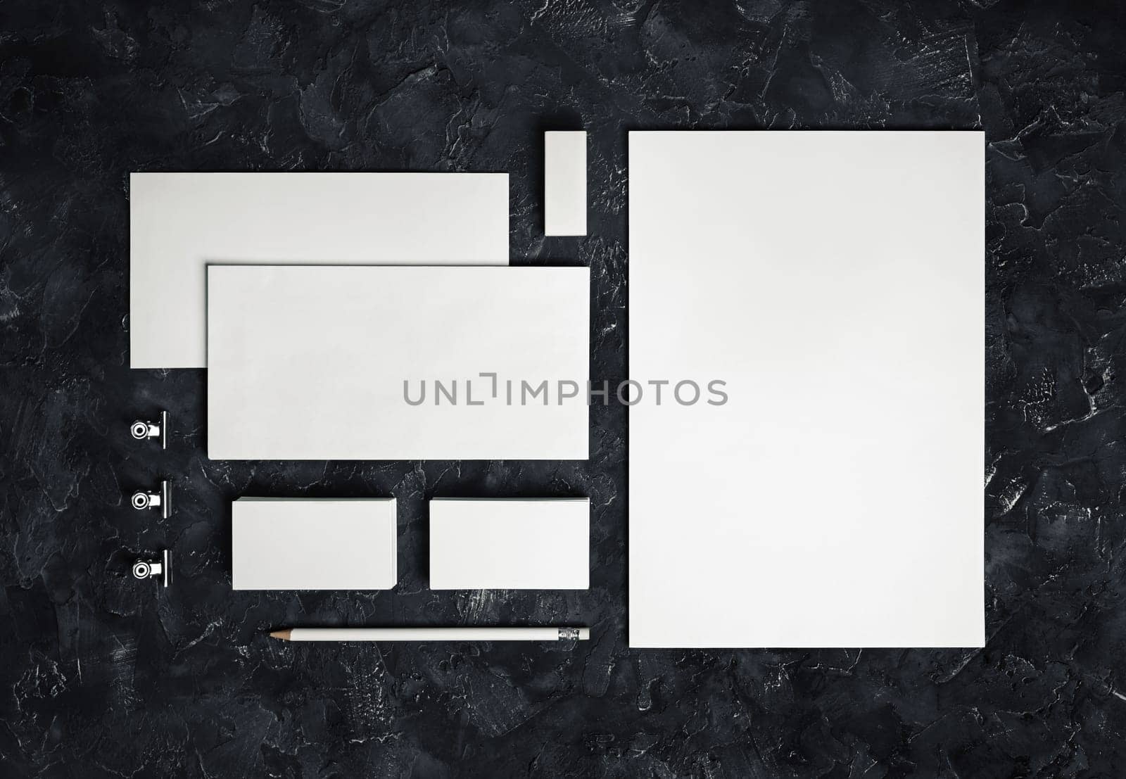 Photo of blank stationery set on black plaster background. Corporate identity template. Responsive design mockup. Top view.