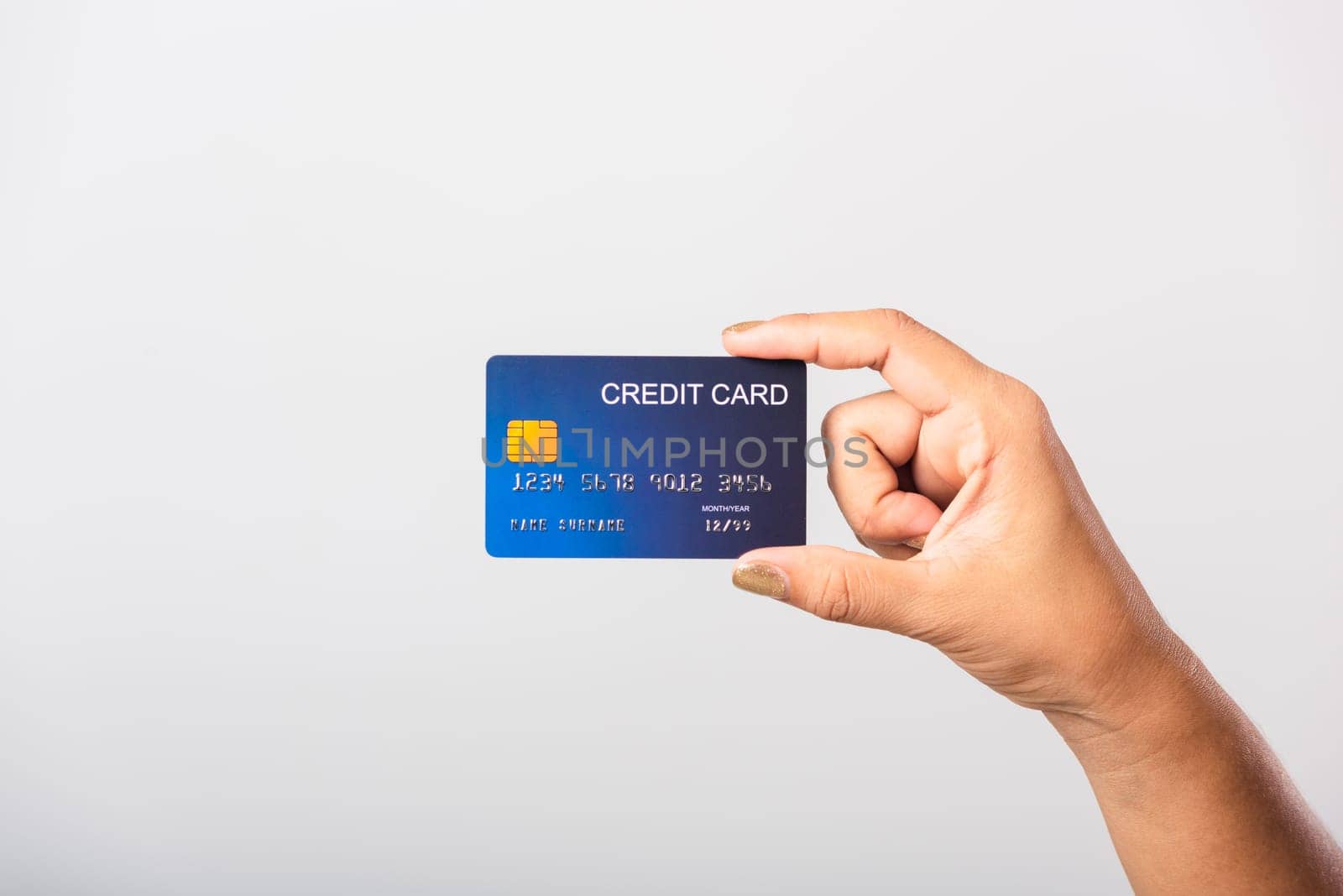 Close up hand of Asian woman she holding bank credit card for pay money online shopping, studio shot isolated on white background