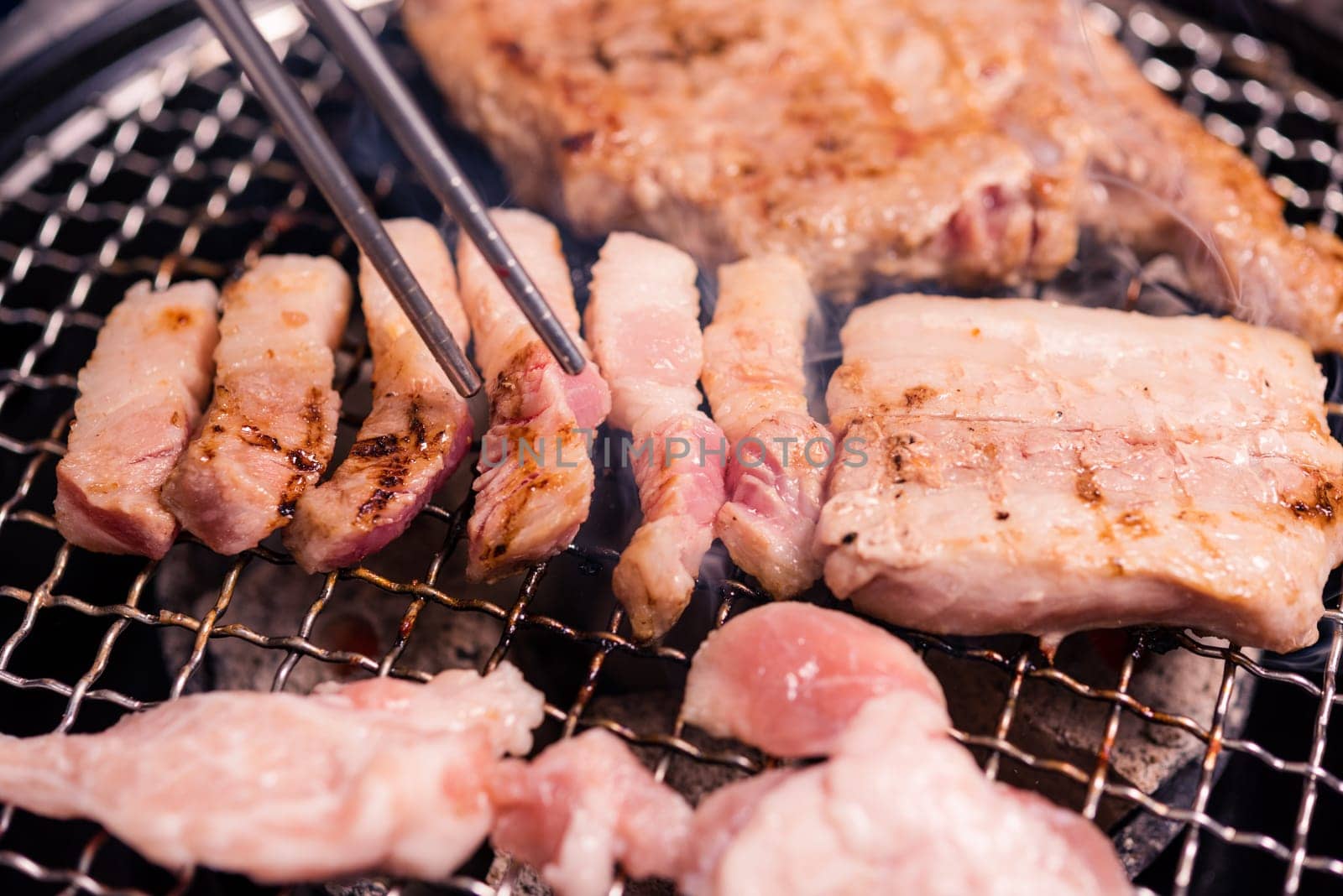 Korean beef barbecue on hot coals. Grilling meat pork Korean BBQ traditional style on stove serve in restaurant, Japanese food