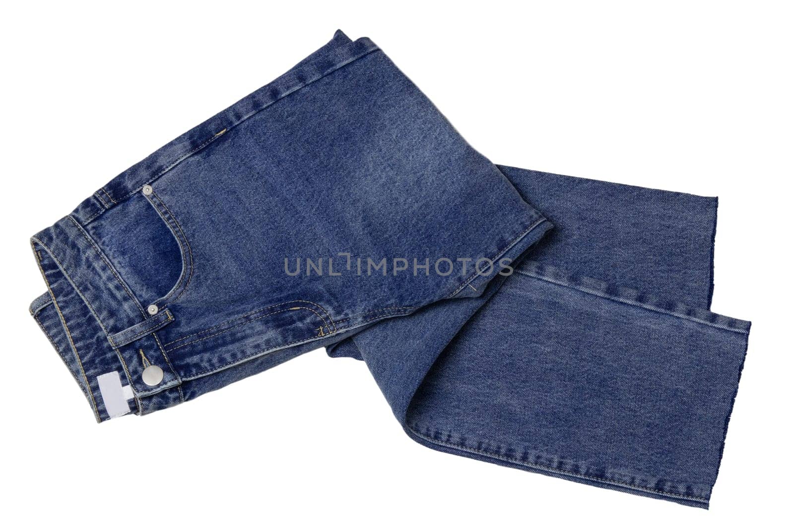 Woman jeans isolated. Folded trendy stylish female blue jeans trousers isolated on a white background. Fashionable denim pants for women.
