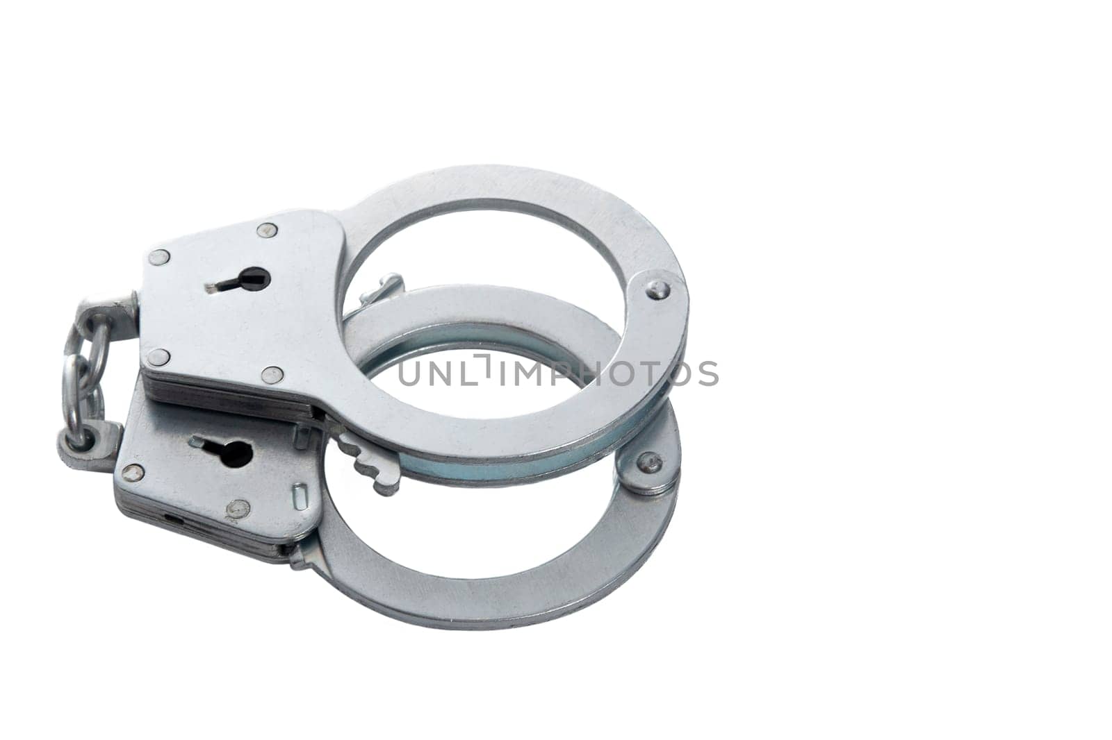 Metal handcuffs on a white isolated background, copy space. High quality photo