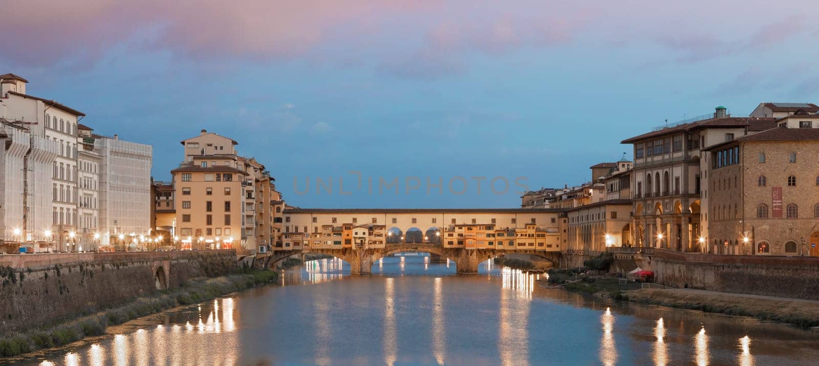 Florence, Italy - circa July 2021. Sunset light on Ponte Vecchio - Old Bridge.