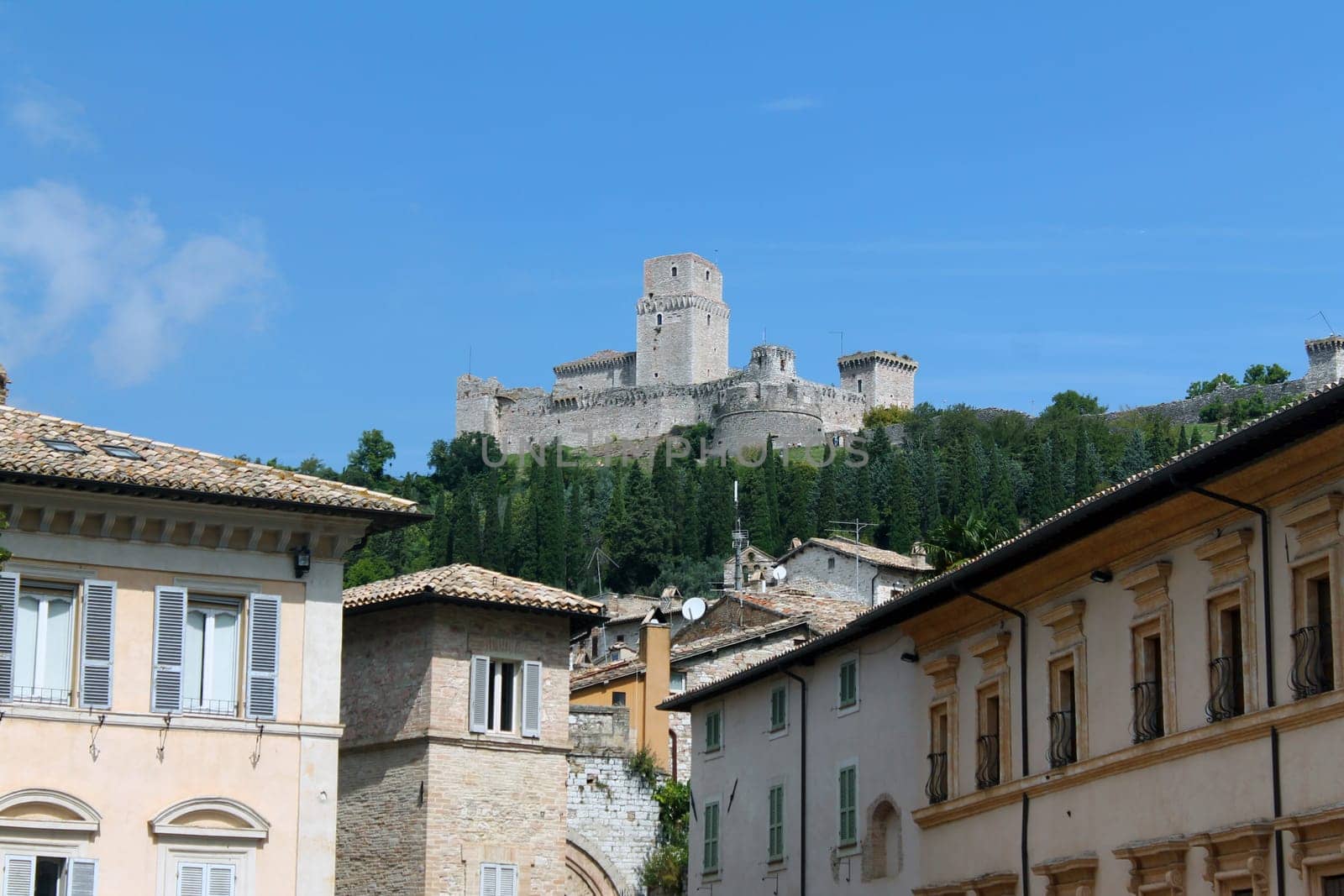 The Rocca Maggiore of Assisi on the top of the hill overlooking the houses below in Umbria in Italy