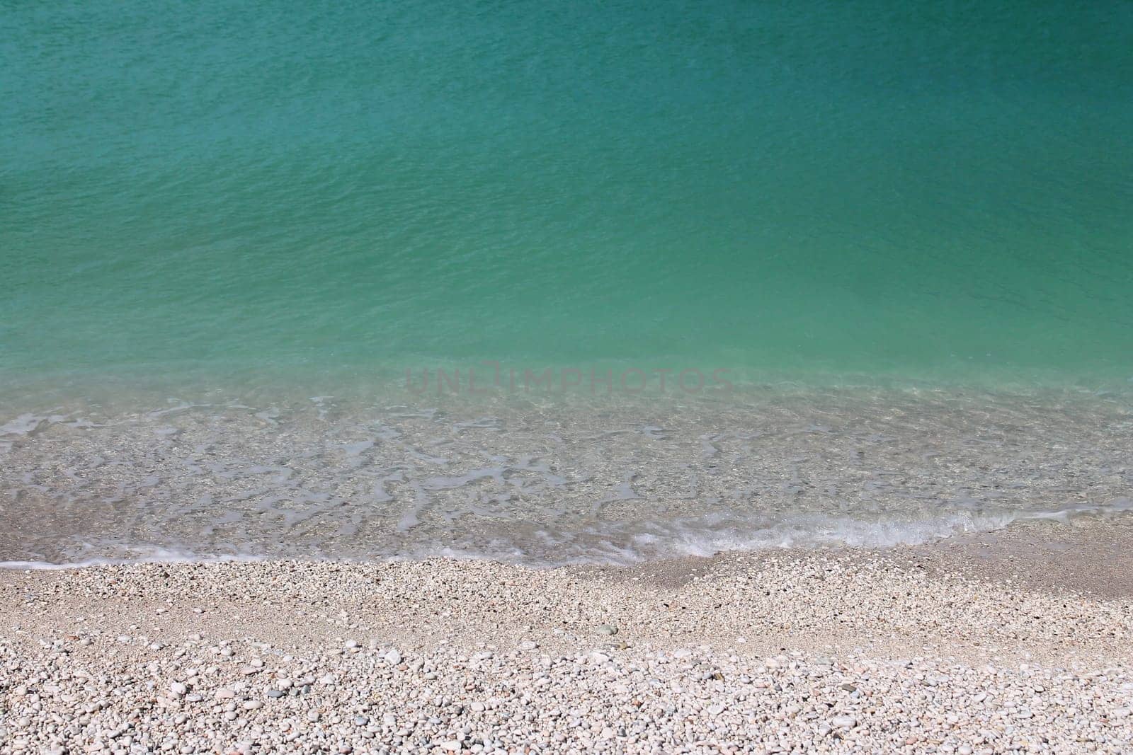 The turquoise water on the white stones of the Conero beaches in Italy