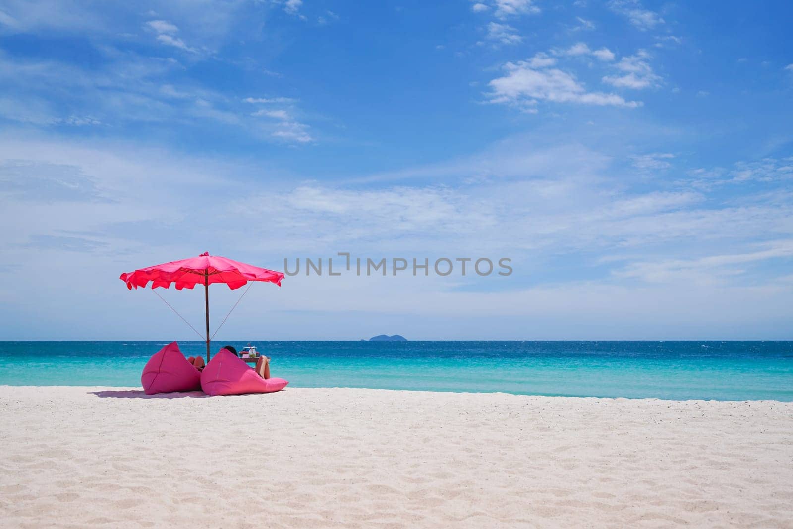 Pink parasol and  seat on the tropical beach, Vacation background.,Idyllic beach
