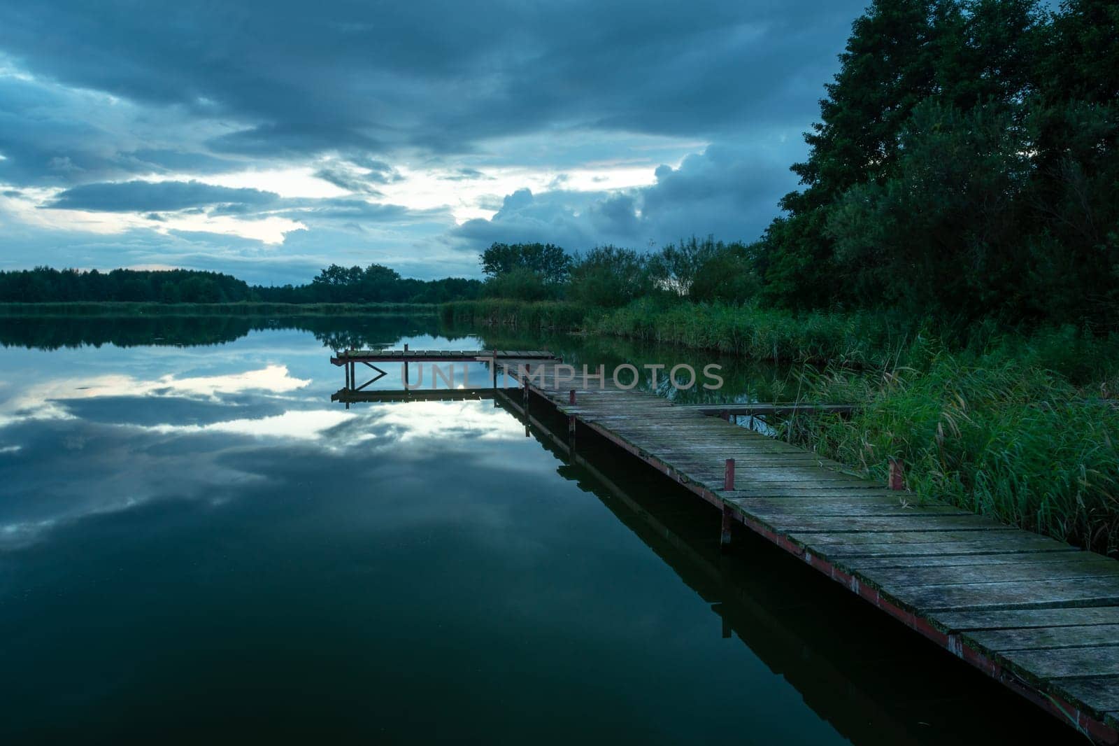 A long wooden pier and a cloudy dark sky, Stankow, Lubelskie, Poland