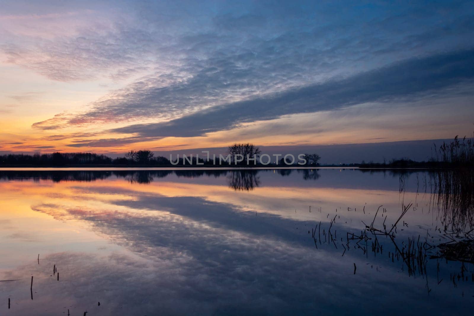 A mirror reflection of the evening clouds in the lake, Stankow, Lubelskie, Poland
