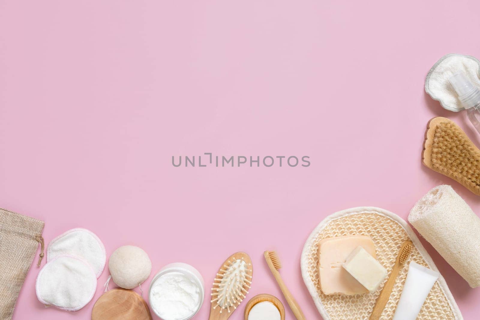 Organic natural cosmetics and zero waste reusable accessories for skin and hair care on pink flat lay with copy space. Top view of eco friendly beauty products for bath, massage or spa salon