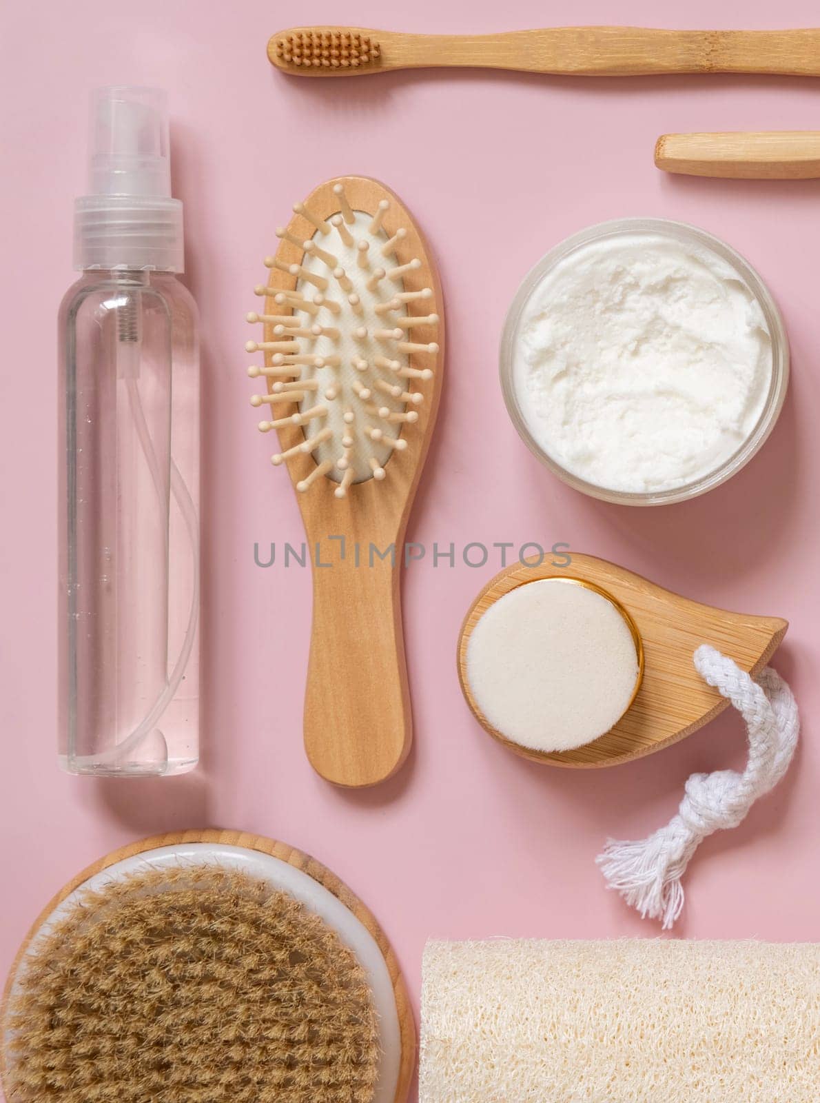 Organic natural cosmetics and zero waste reusable accessories for skin and hair care on pink flat lay. Top view of eco friendly beauty products for bath, massage or spa salon