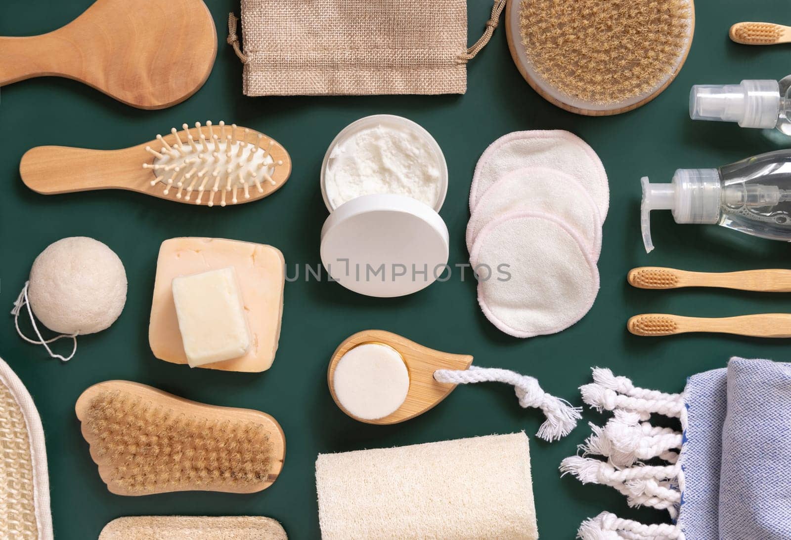 Organic natural cosmetics and zero waste reusable accessories for skin and hair care on dark green flat lay. Top view of eco friendly beauty products for bath, massage or spa salon