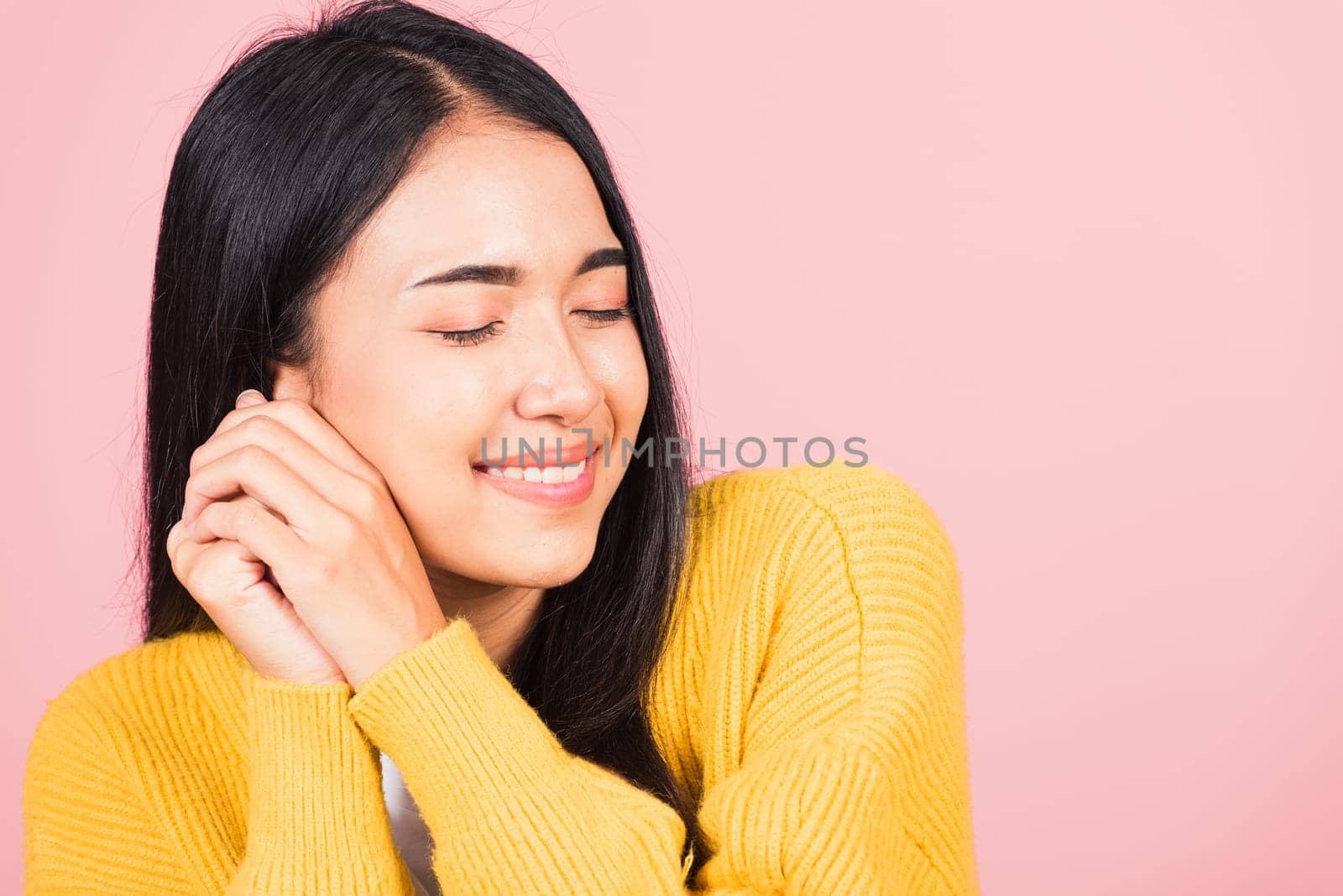 Happy Asian portrait beautiful cute young cheerful mixed race woman smile shy satisfied expression, studio shot isolated pink background, Thai female bashful pleasure put both hand on face, copy space