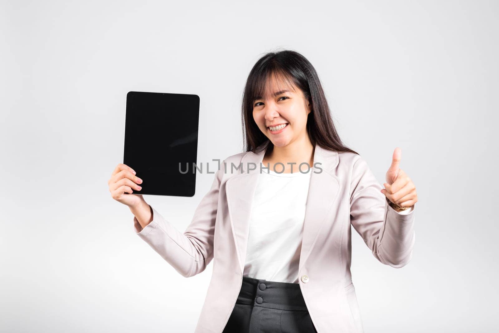 Asian beautiful young woman smiling using tablet computer, Happy female show blank screen digital tablet pc and show thumb up finger for good sign, studio shot isolated on white background