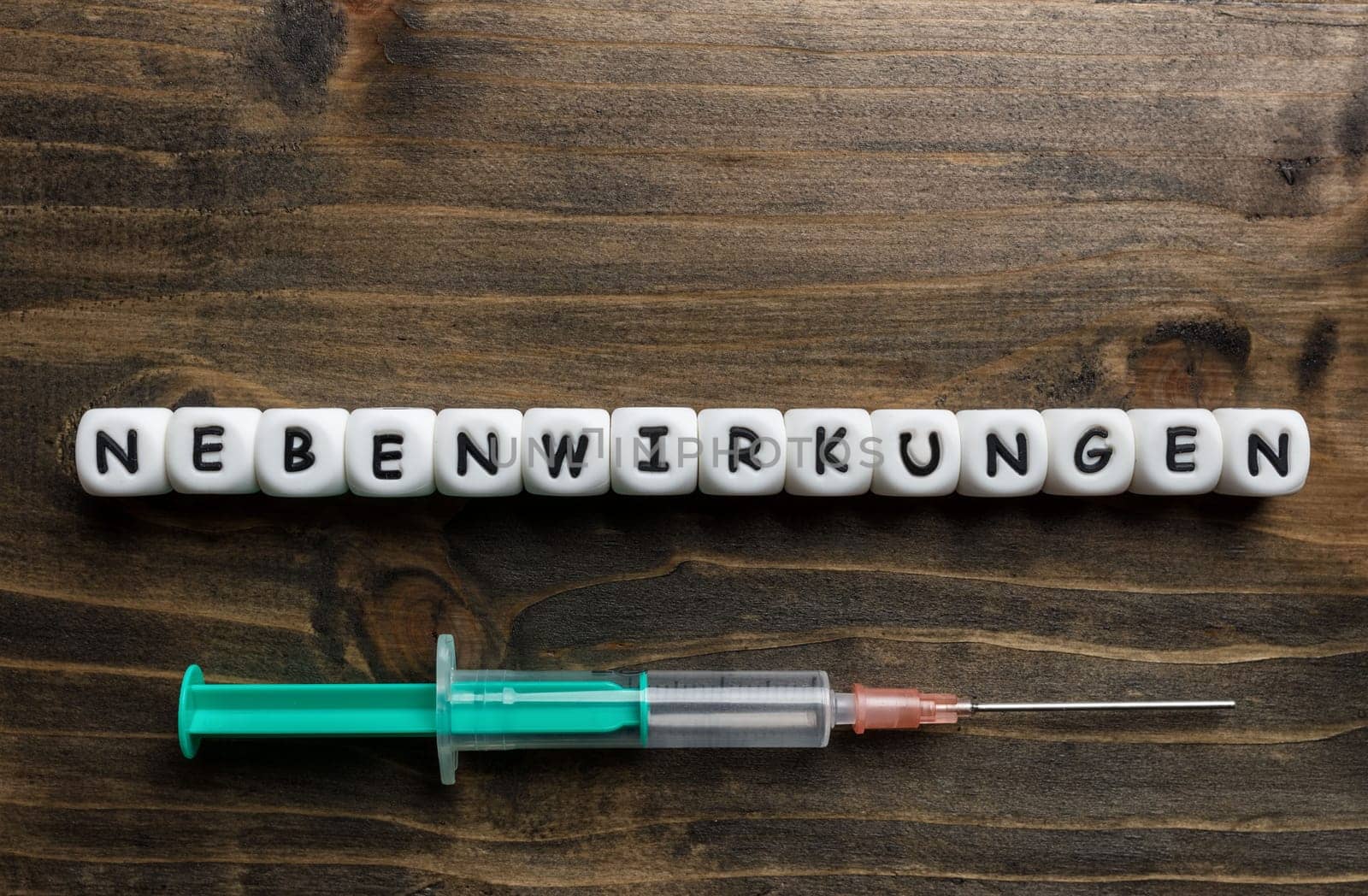 Corona virus Covid-19 vaccine text in German on wooden background