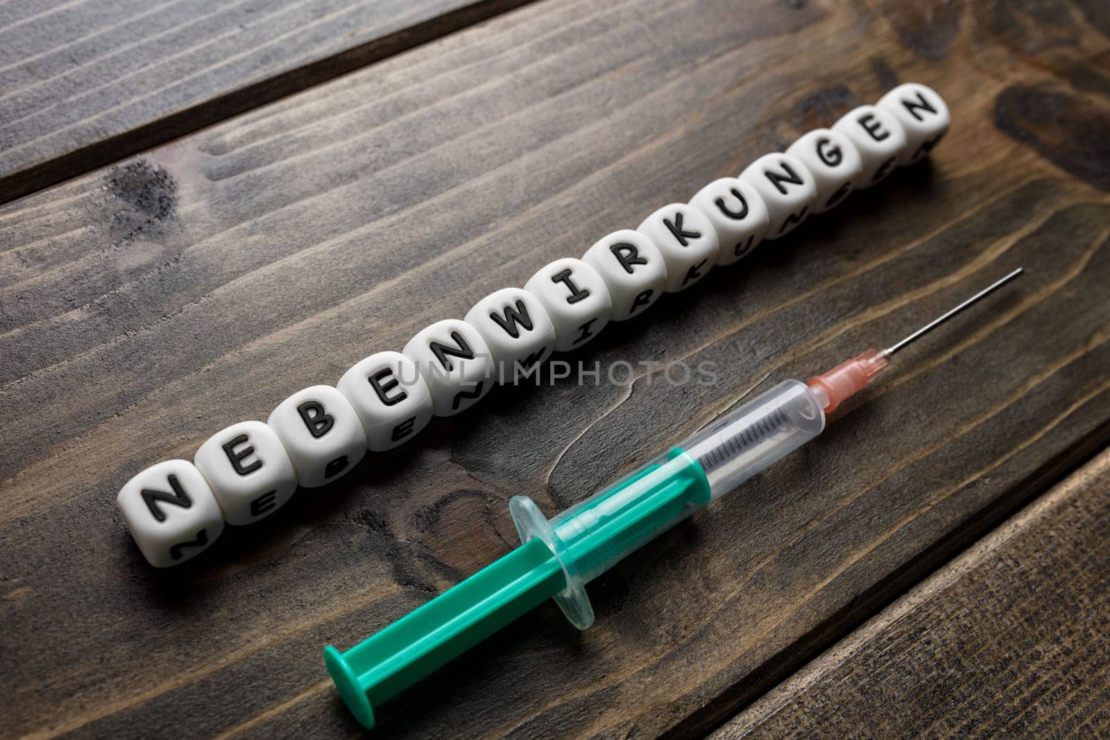 Corona virus Covid-19 vaccine text in German on wooden background