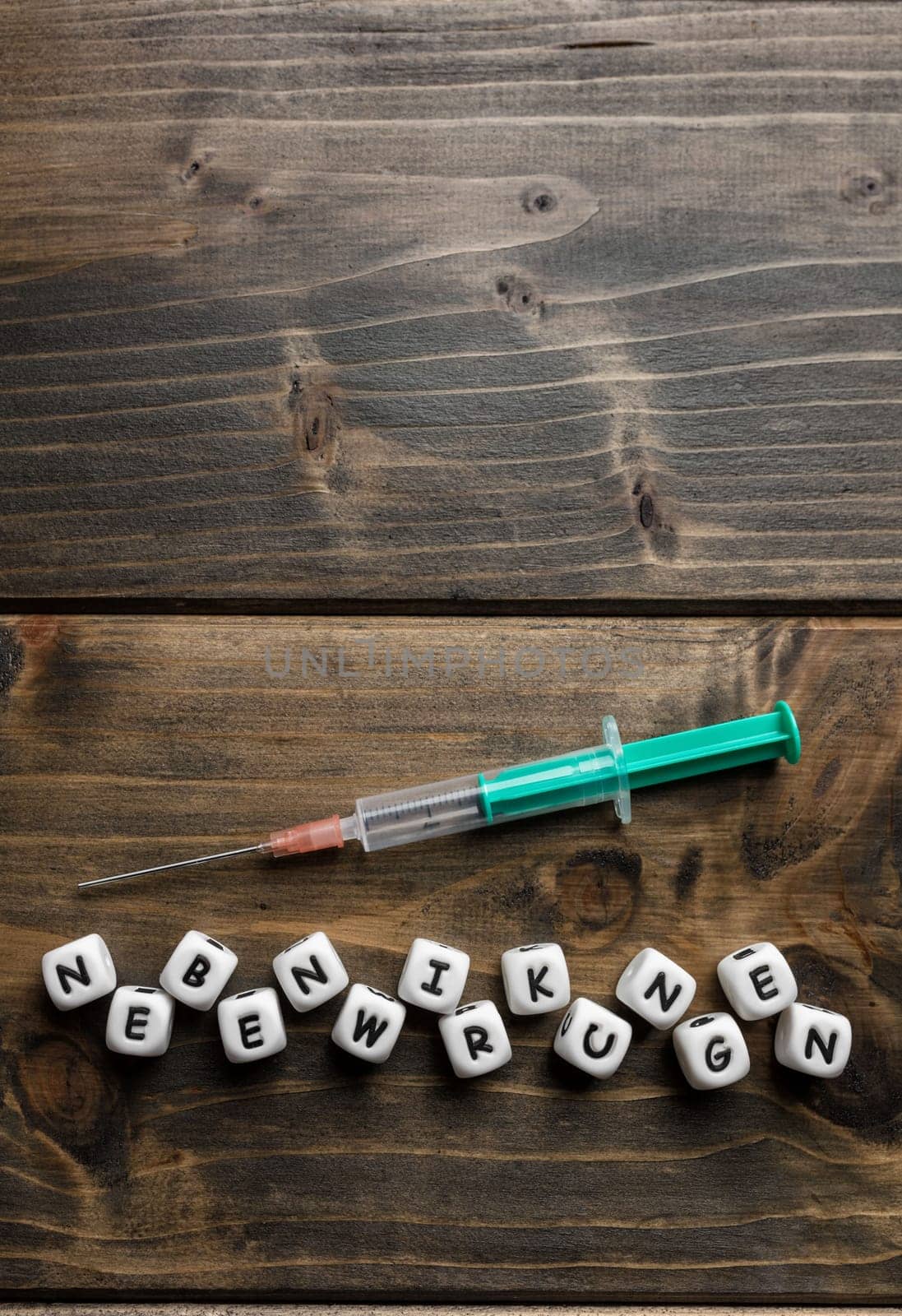 Corona virus Covid-19 vaccine text in German on wooden background