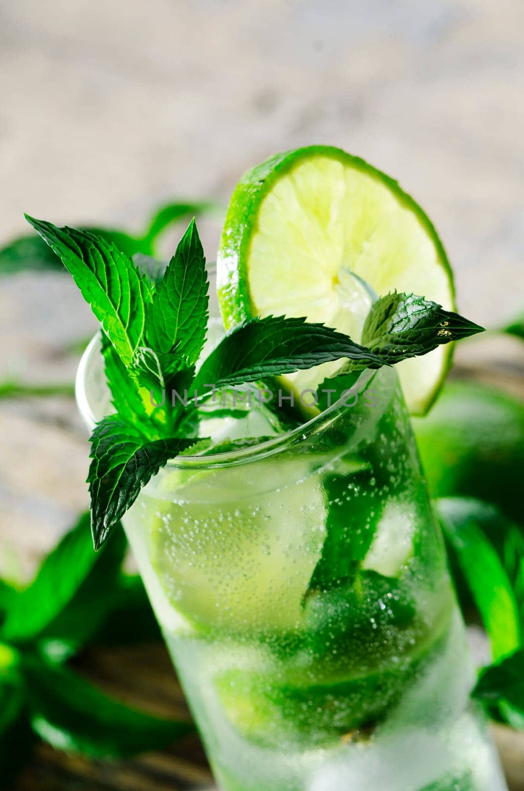 Mojito cocktail on wooden table closeup
