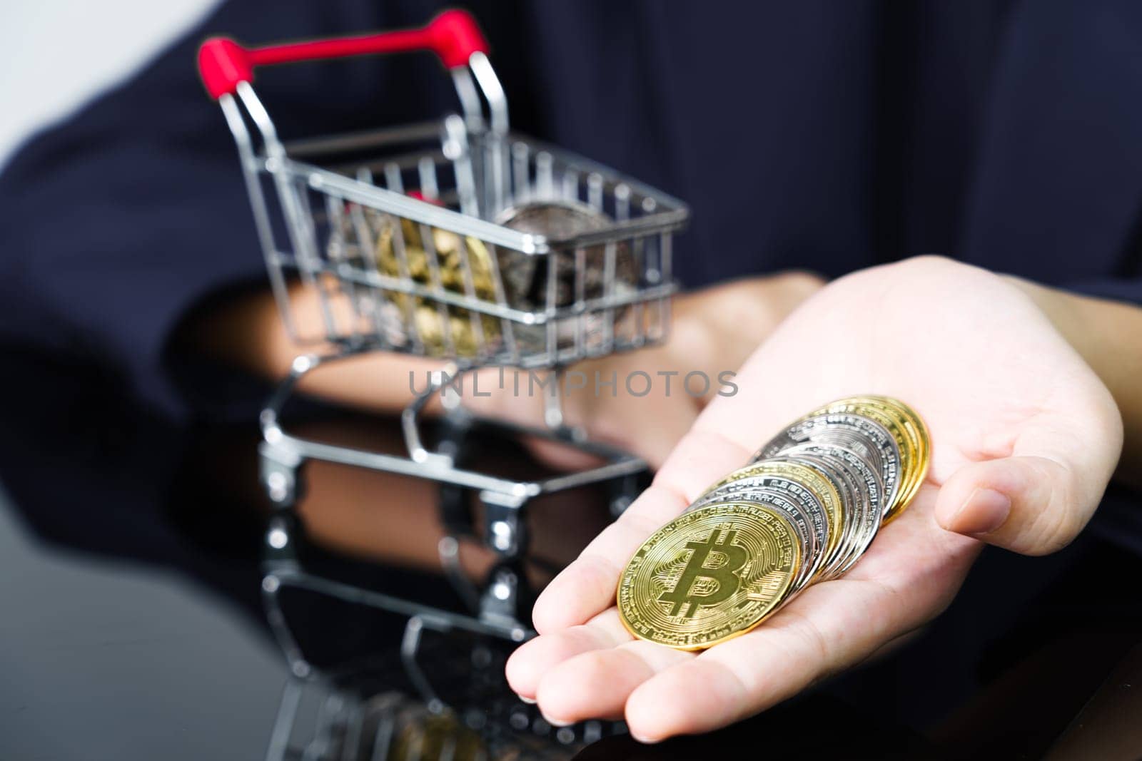 Closeup image of a business women holding and giving golden color bitcoins