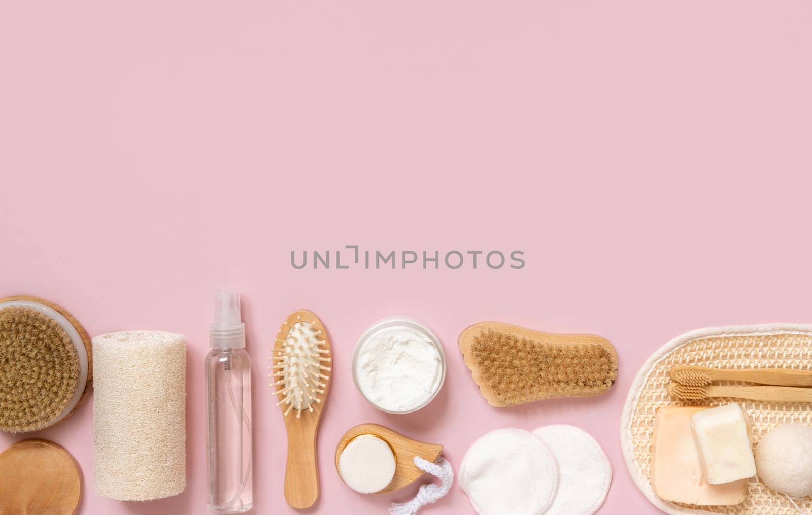 Organic natural cosmetics and zero waste reusable accessories for skin and hair care on pink flat lay with copy space. Top view of eco friendly beauty products for bath, massage or spa salon