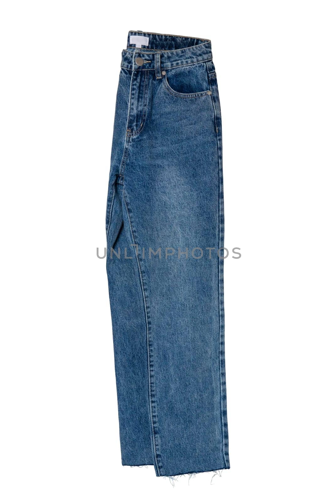 Woman jeans isolated. Folded trendy stylish female blue jeans trousers isolated on a white background. Clipping path. Fashionable denim pants for women.