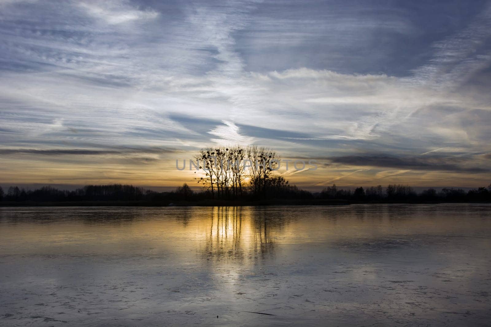 Sunset reflection in a frozen lake, January evening, Stankow, Poland