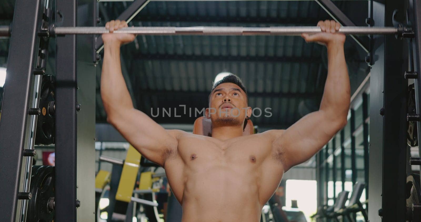 Muscular man working out exercise for triceps push down weightlifting with pull machine to flexing muscles at fitness gym, Sport fit workout bodybuilding concept