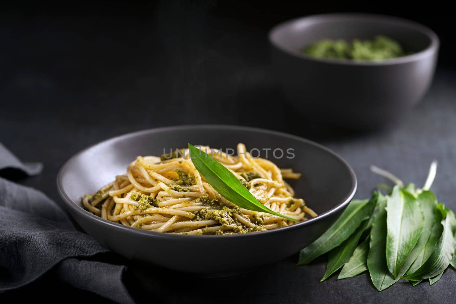 Making Fresh pasta with ramson or wild garlic pesto closeup. Healthy spring food concept