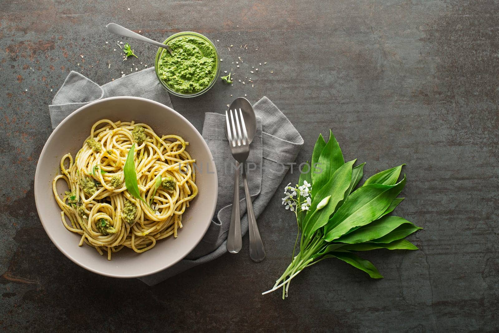 Making Fresh pasta with ramson or wild garlic pesto. Healthy spring food concept