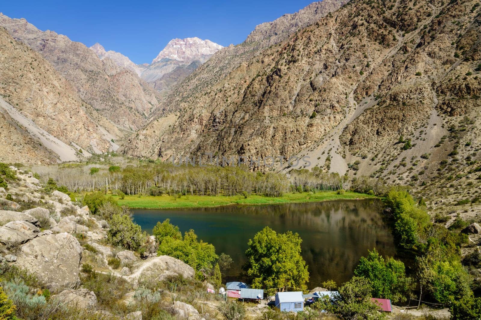 Scenic view of the mountains, small lake and a tourist camp in Tajikistan