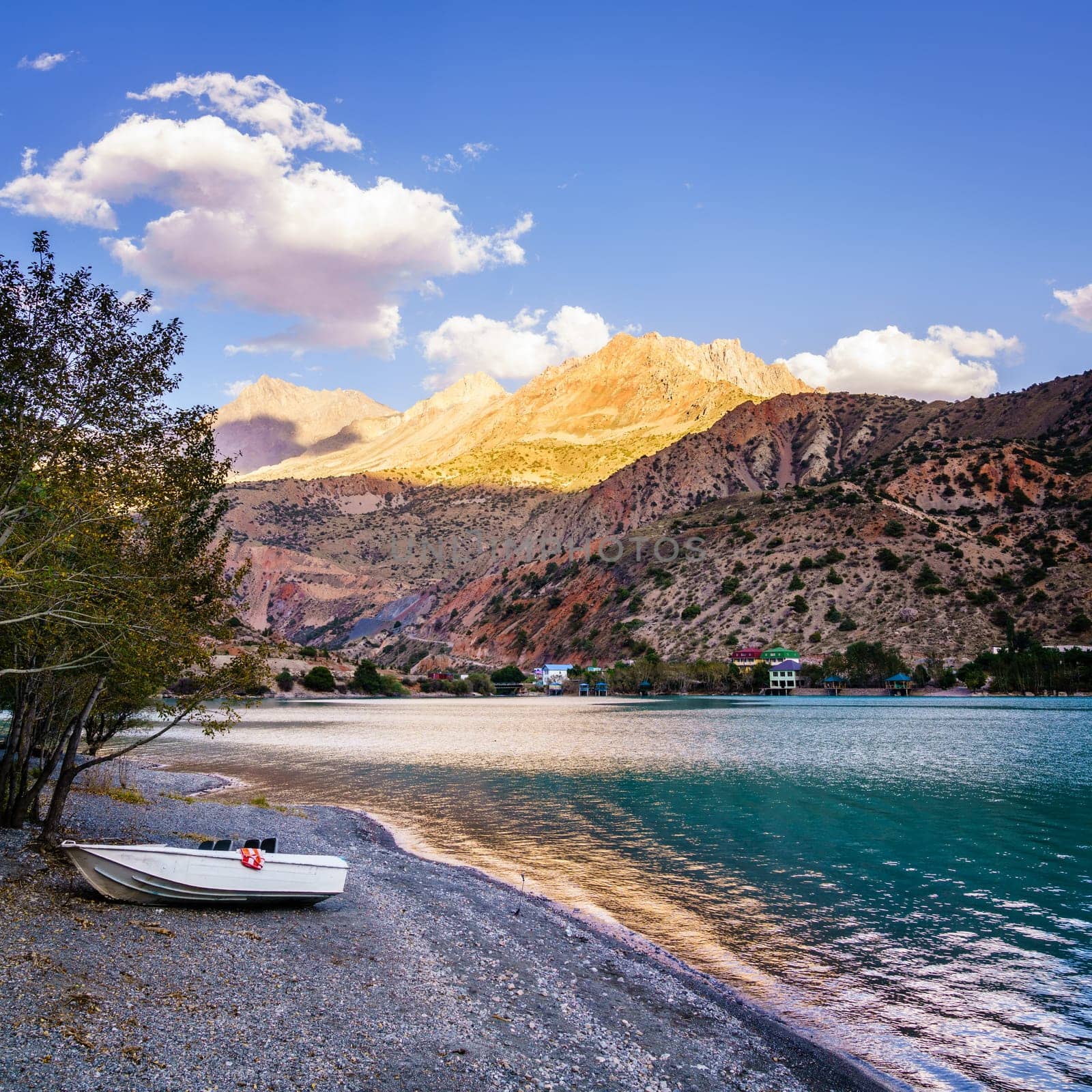Evening scene on the shore of alpine lake Iskanderkul in Tajikistan