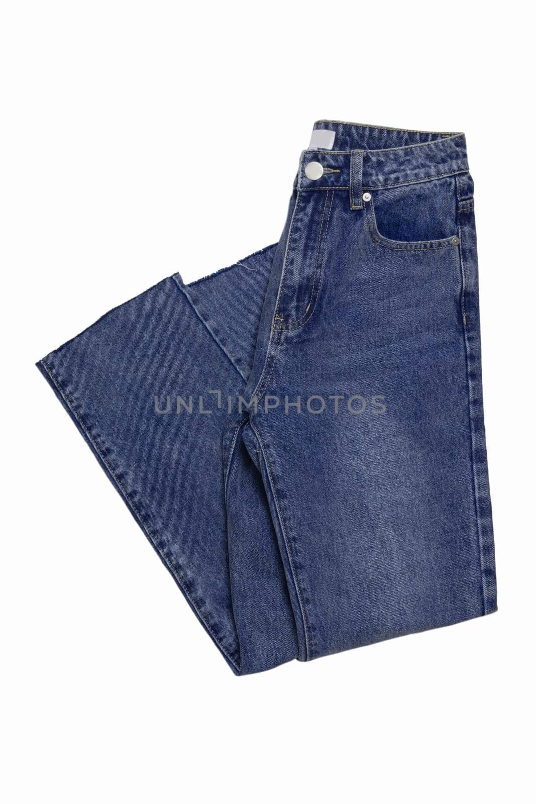 Woman jeans isolated. Folded trendy stylish female blue jeans trousers isolated on a white background. Fashionable denim pants for women.