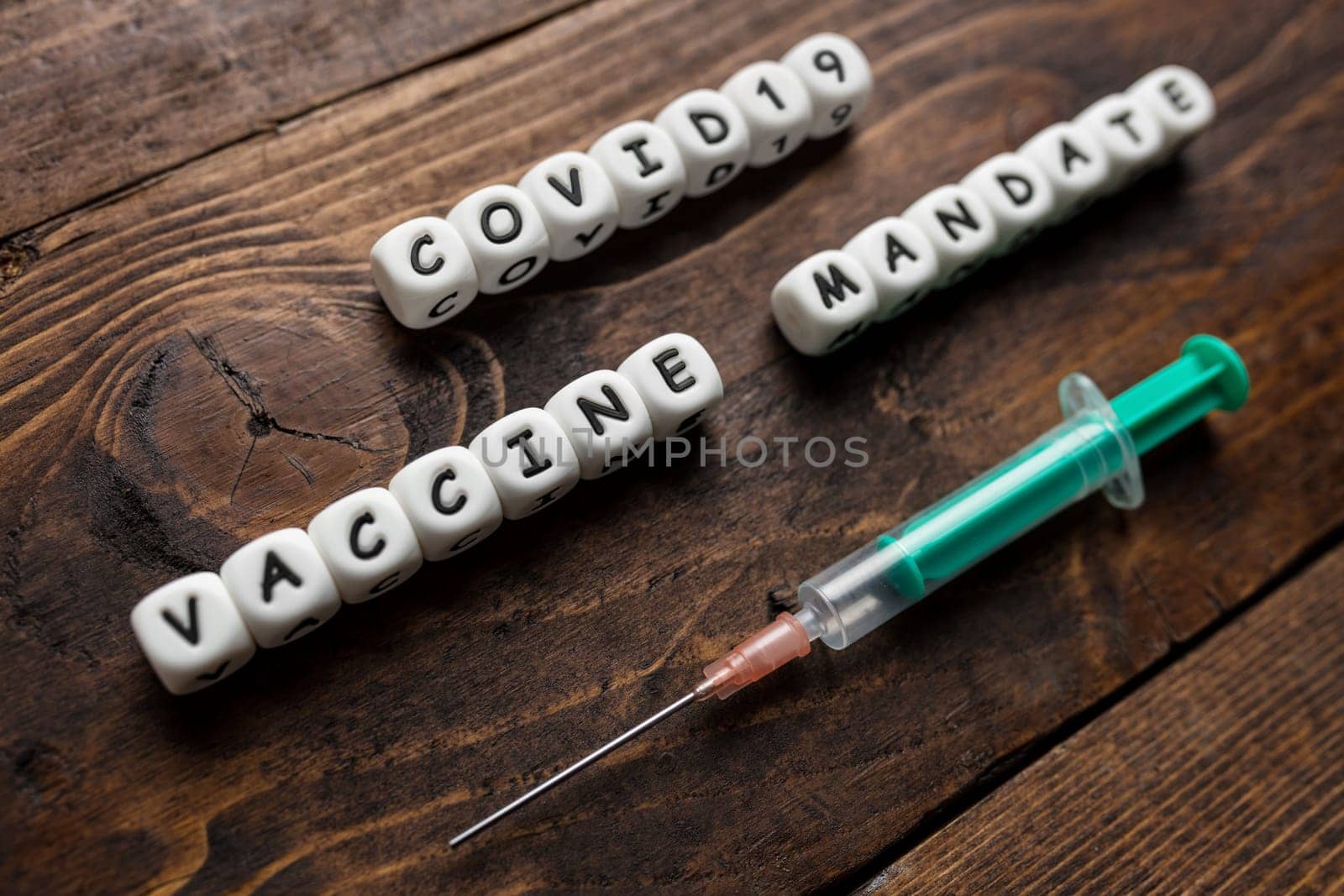 Corona virus Covid-19 vaccine text on wooden background