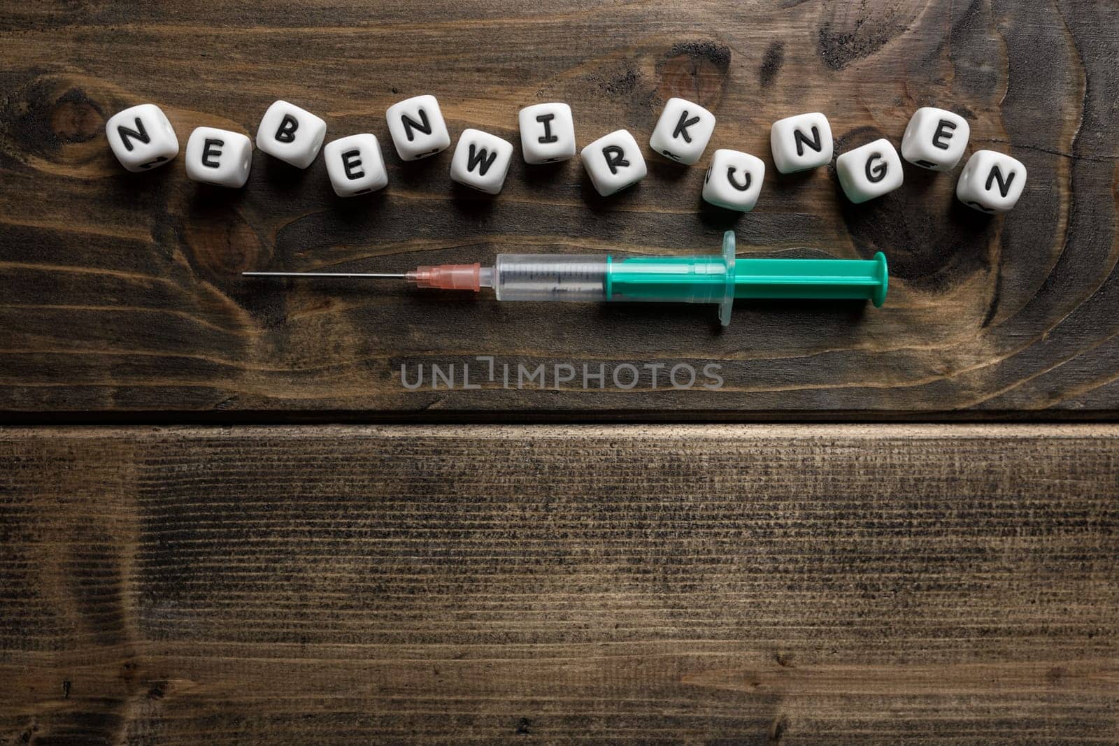 Corona virus Covid-19 vaccine text in German on wooden background
