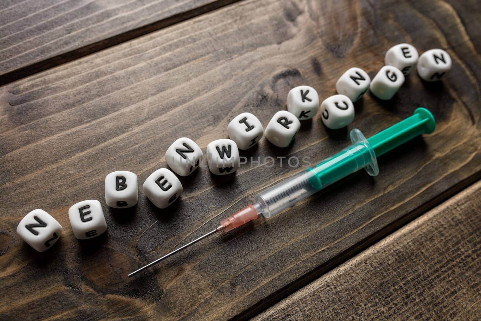 Corona virus Covid-19 vaccine text in German on wooden background