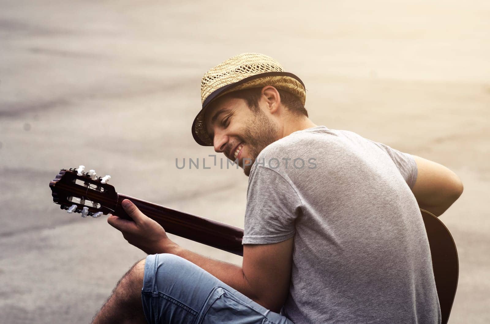 Man playing guitar on the street. retro style.