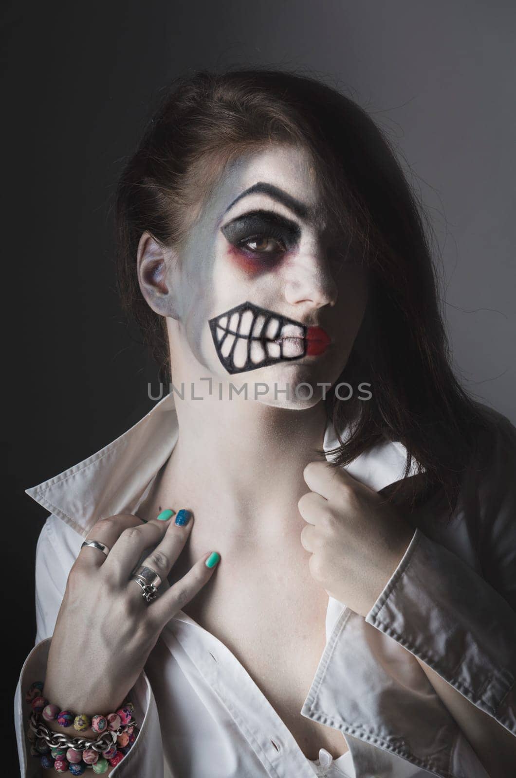 Girl with halloween mask on her face