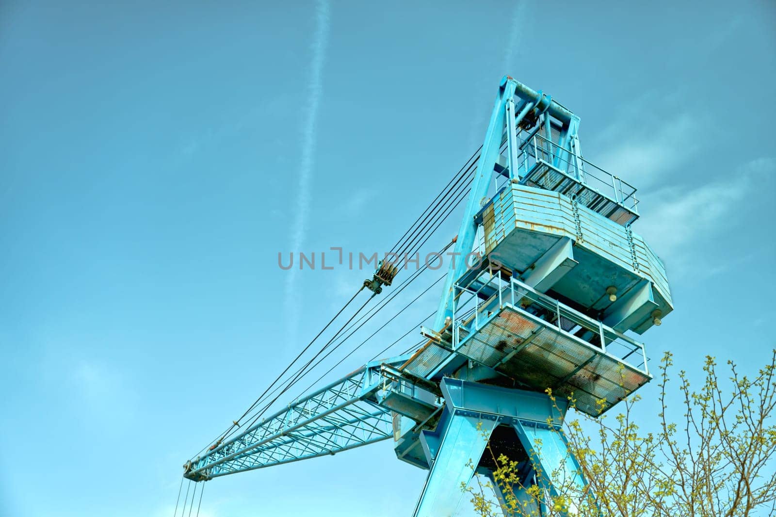 blue crane on a blue sky in worms-eye view, color image tone-in-tone,