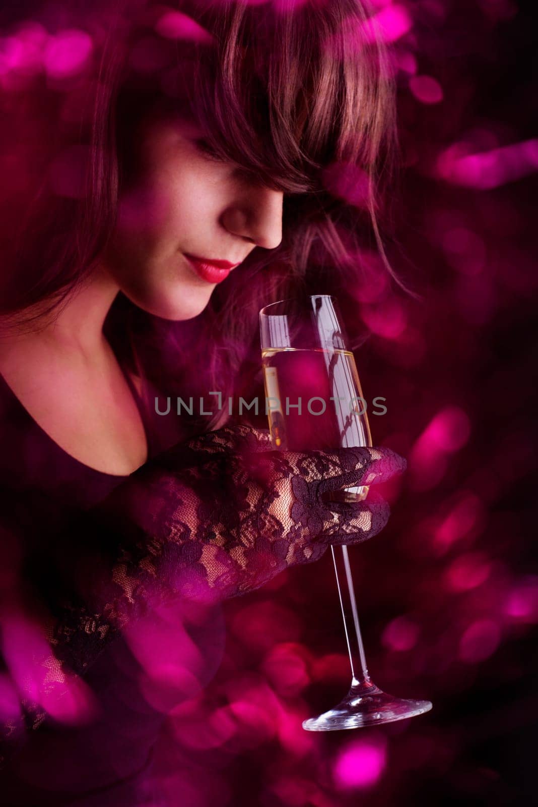 Beautiful young woman holding champagne glass.