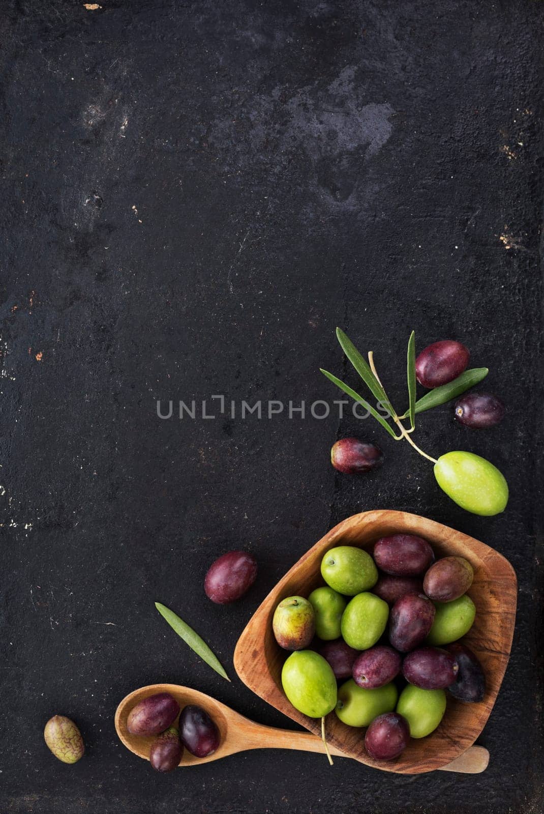 Fresh olives on black rustic background