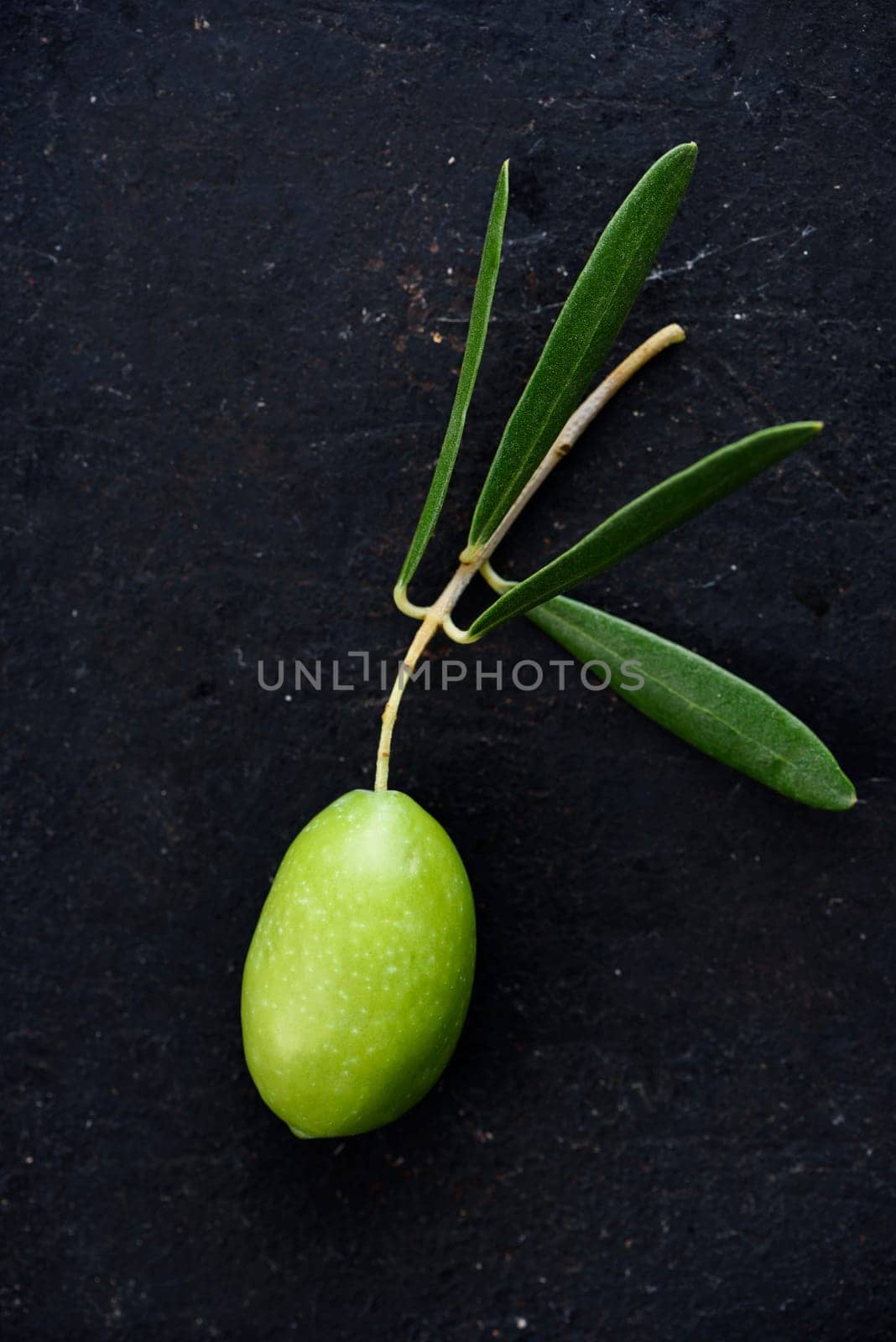 Fresh olive on black rustic background