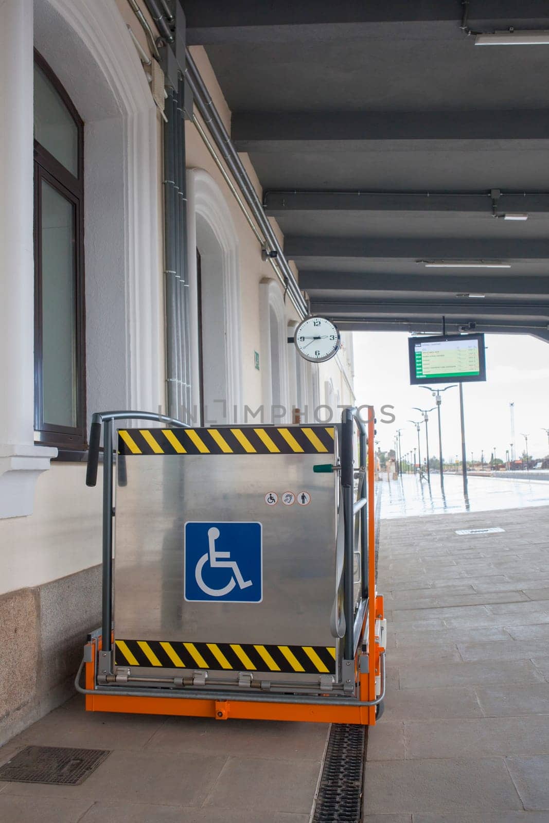 Special lift for wheelchairs at railway station. Assistance service for railway disabled passengers