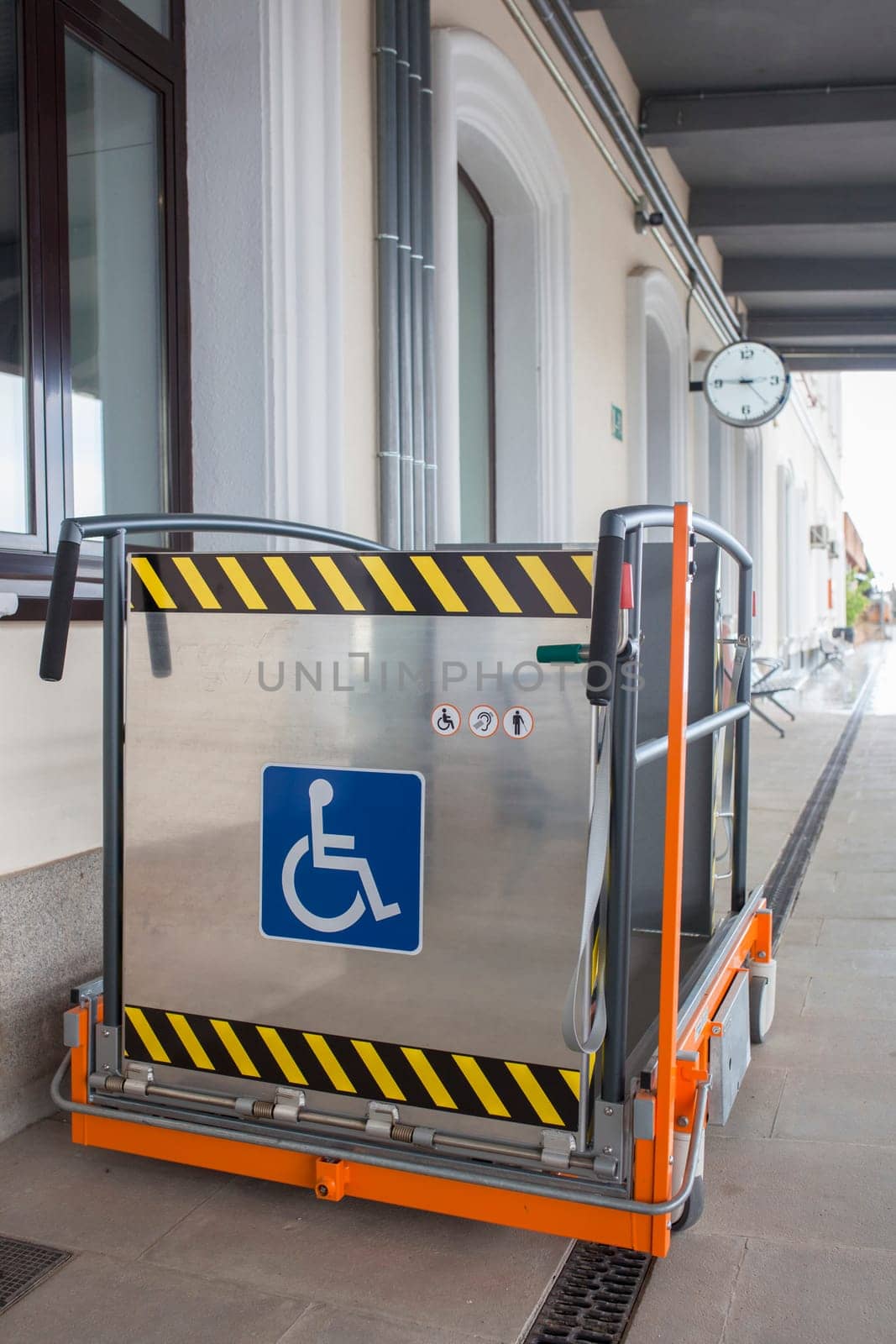 Special lift for wheelchairs at railway station. Assistance service for railway disabled passengers